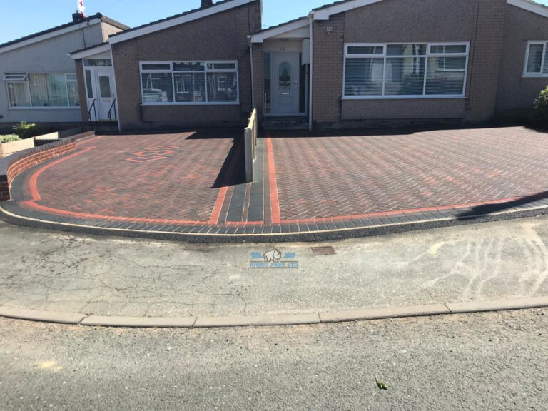 Two Adjacent Block Paved Driveways with a Fence in Holywell, Flintshire